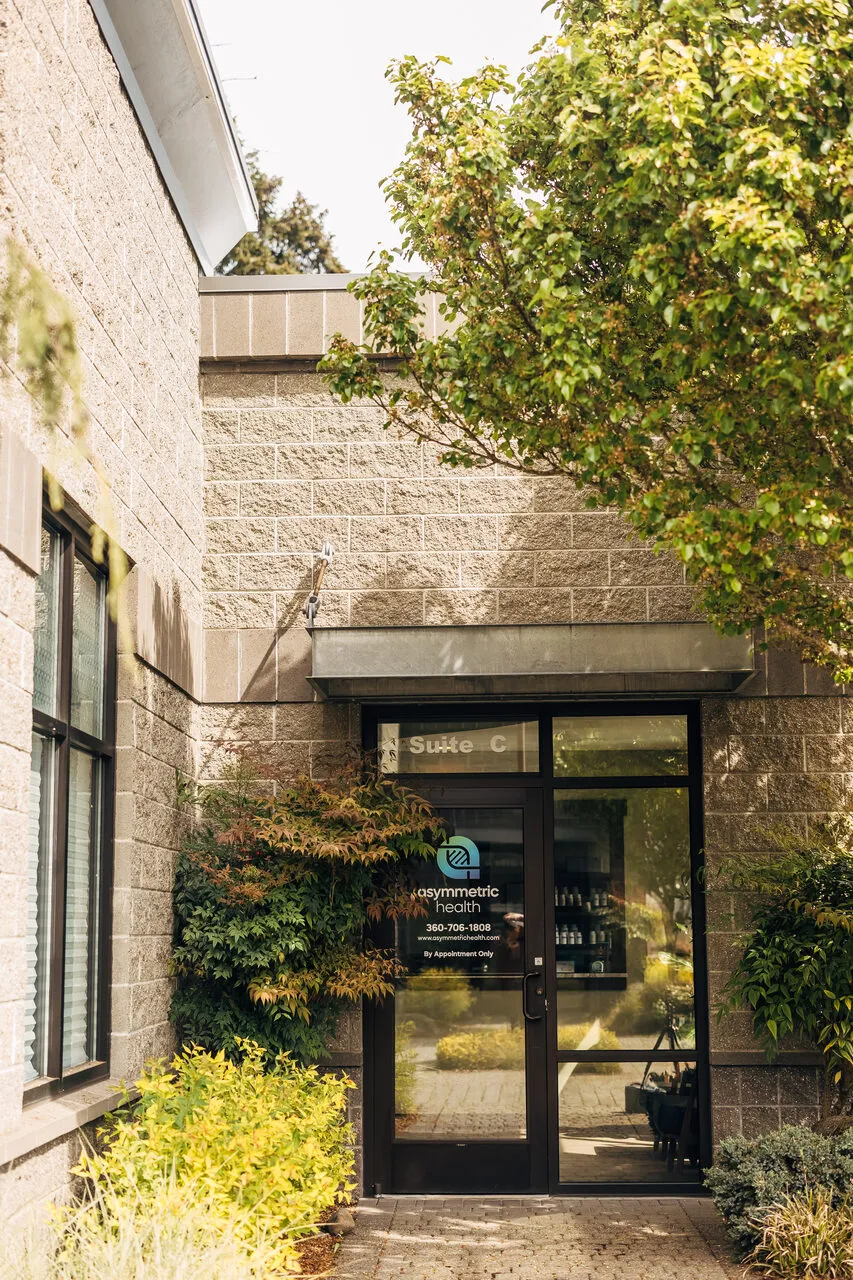 Suite C entrance of Asymmetric Health, 8282 28th Ct NE, Lacey, WA, framed by Japanese maple foliage