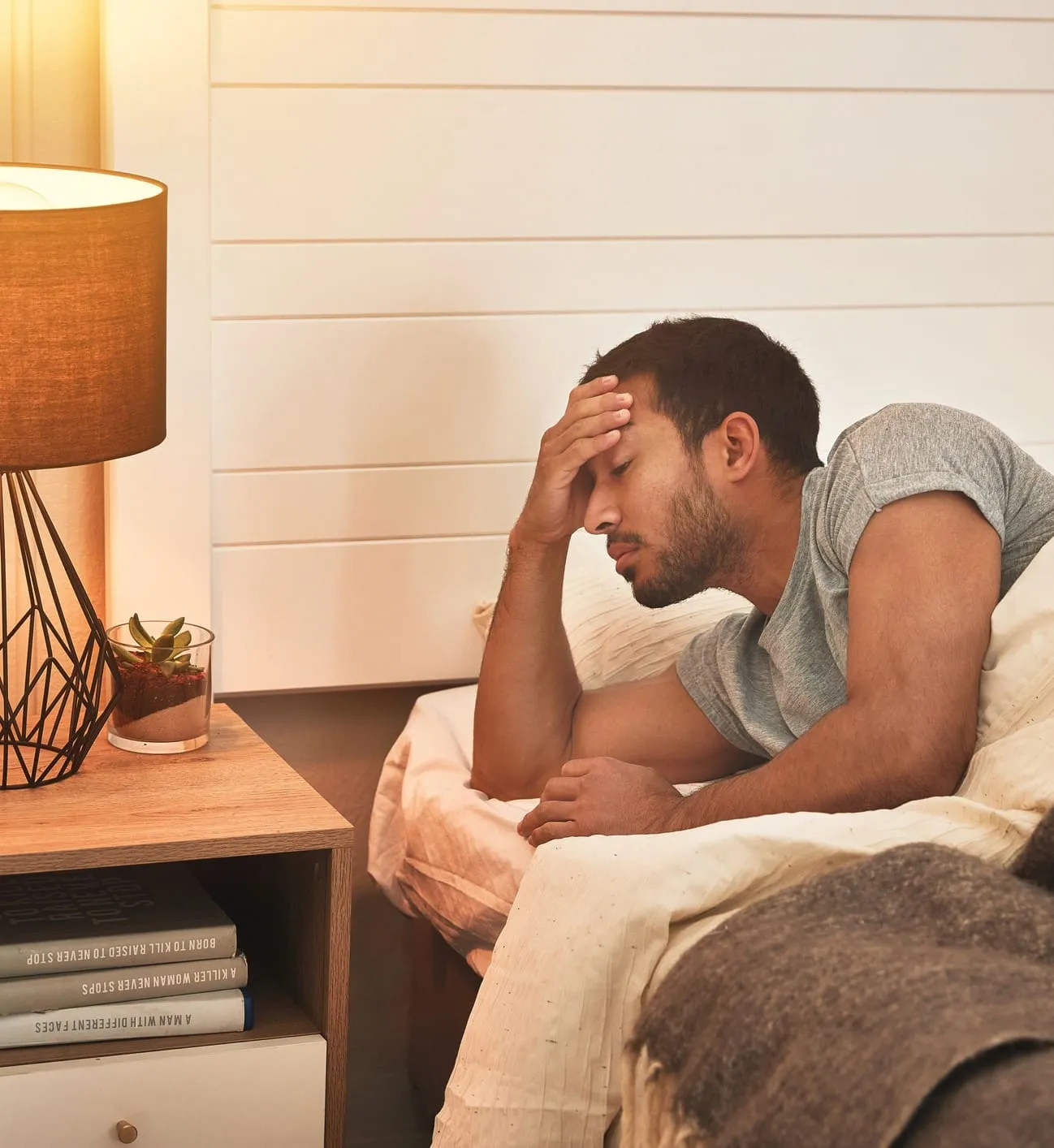 Person sleeping peacefully in a dark, cool bedroom