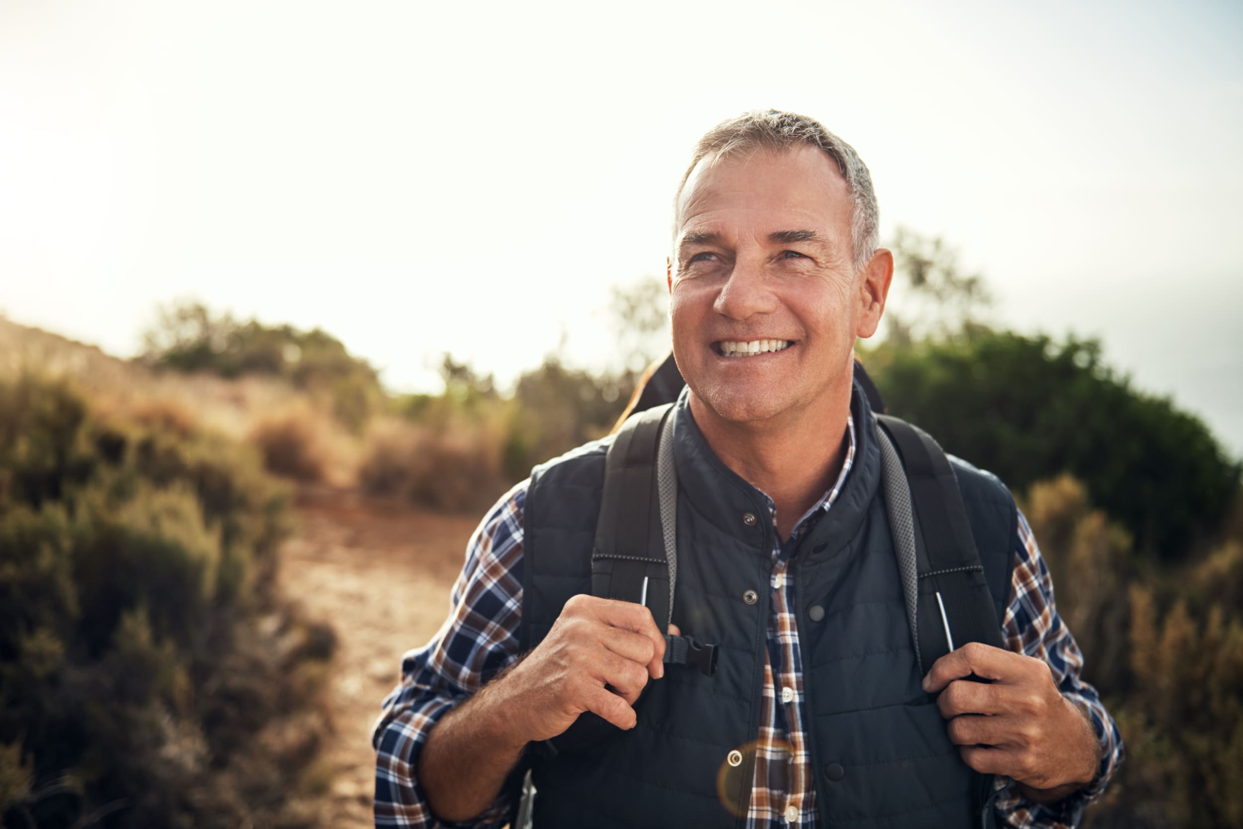 iStock-1142154154-scaled middle aged hiker with backpack